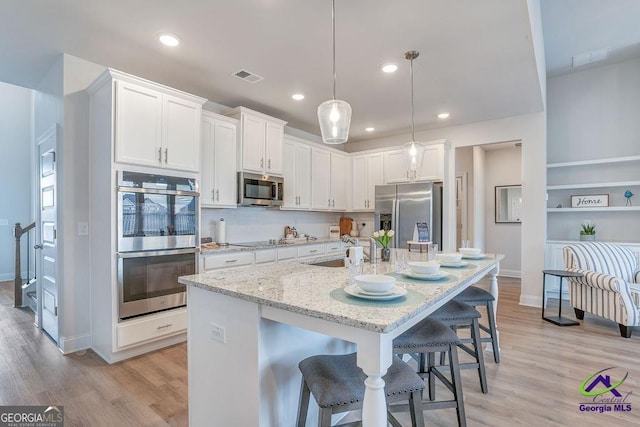 422 Chelsea Leigh Ave, Bonaire, GA 31005 - kitchen with visible vents, white cabinets, appliances with stainless steel finishes, and baseboards