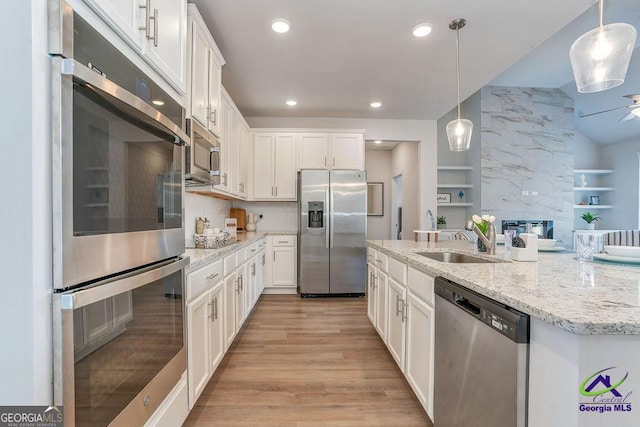422 Chelsea Leigh Ave, Bonaire, GA 31005 - kitchen with light wood-type flooring, white cabinetry, recessed lighting, a sink, and stainless steel appliances