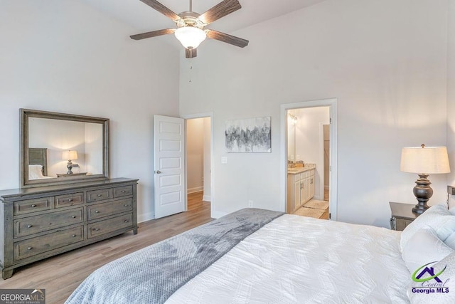 422 Chelsea Leigh Ave, Bonaire, GA 31005 - bedroom with wood finished floors, high vaulted ceiling, baseboards, and ensuite bathroom