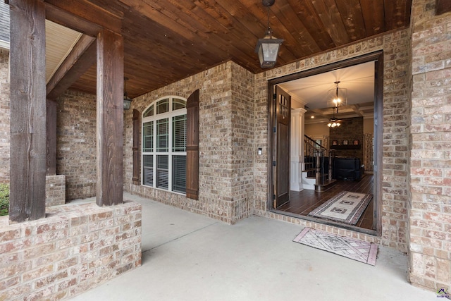 view of exterior entry featuring brick siding