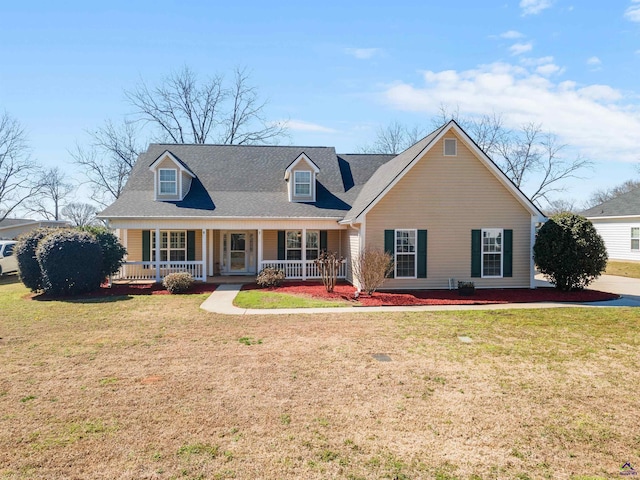 cape cod house featuring covered porch and a front lawn