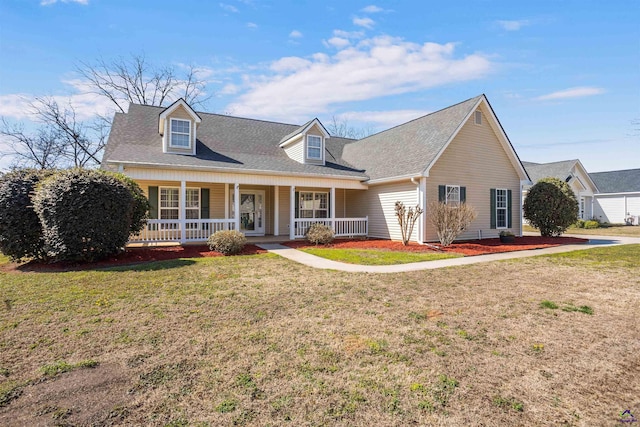 cape cod-style house featuring covered porch, a shingled roof, and a front yard