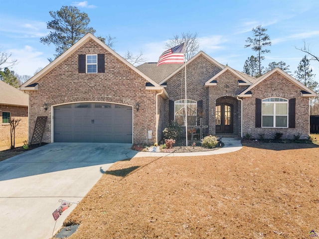 view of front of property with driveway, a front lawn, french doors, and brick siding