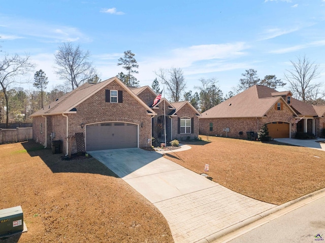 traditional-style house with a garage, brick siding, fence, driveway, and a front lawn