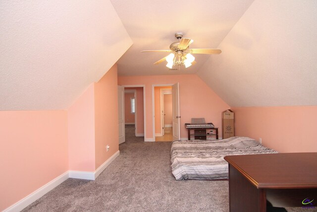 carpeted bedroom with vaulted ceiling, a ceiling fan, and baseboards
