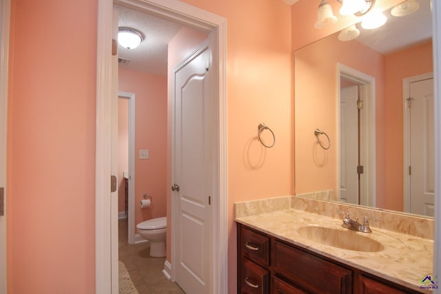 bathroom with visible vents, vanity, toilet, and tile patterned floors