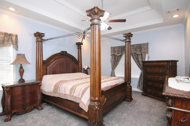 carpeted bedroom with visible vents, a raised ceiling, ceiling fan, crown molding, and recessed lighting
