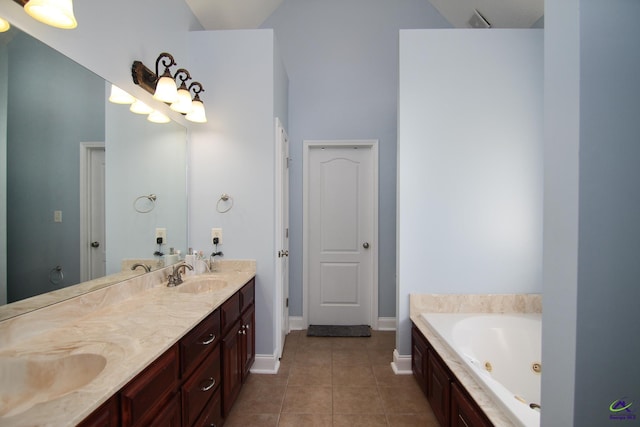 bathroom with a whirlpool tub, double vanity, a sink, and tile patterned floors
