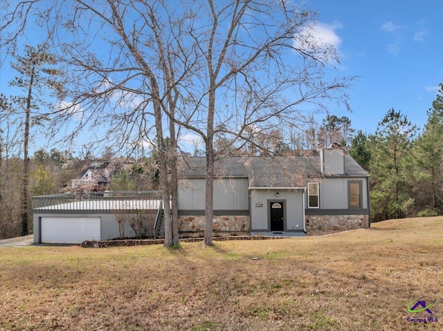 view of front of property with stone siding, a chimney, and a front lawn