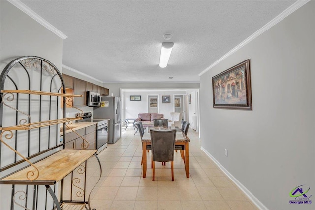 dining room with light tile patterned floors, a textured ceiling, baseboards, and crown molding