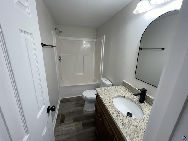 full bathroom featuring shower / bath combination, visible vents, toilet, vanity, and wood finished floors