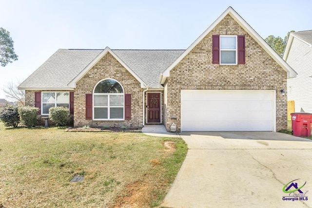 traditional-style home featuring brick siding, a shingled roof, concrete driveway, an attached garage, and a front yard