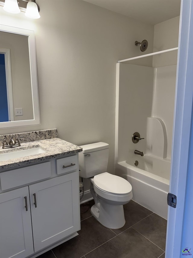 full bath with tile patterned flooring, shower / bathing tub combination, vanity, and toilet