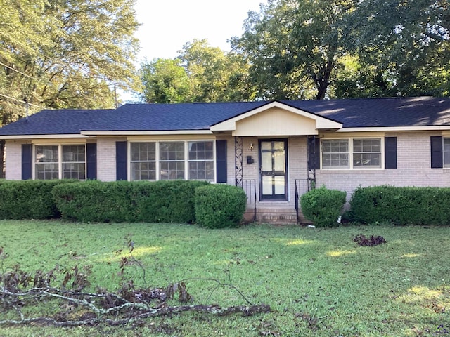 ranch-style house with brick siding and a front lawn