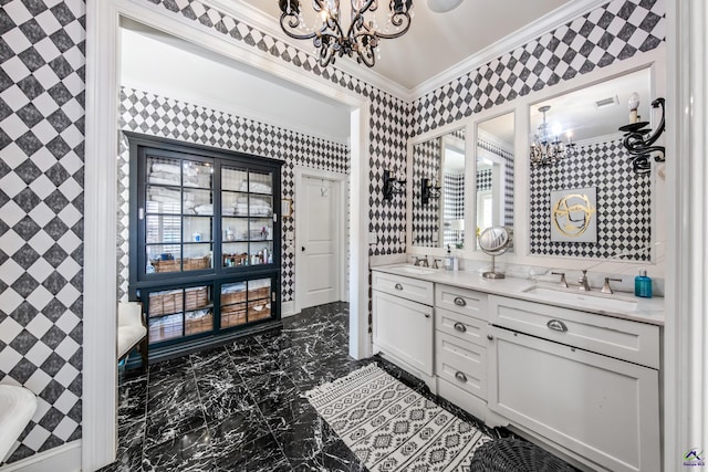 bathroom with crown molding, a notable chandelier, a sink, and wallpapered walls