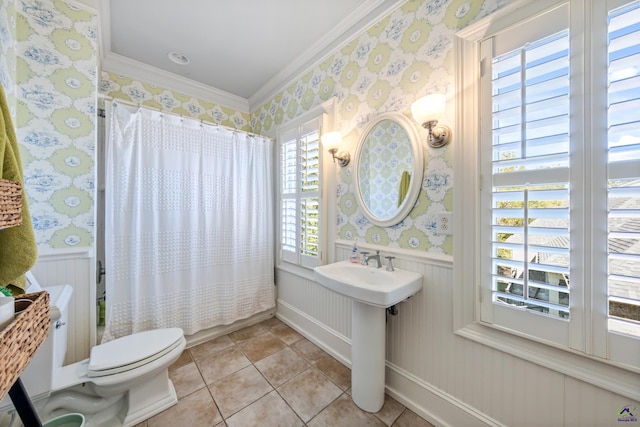 bathroom with ornamental molding, wainscoting, and wallpapered walls