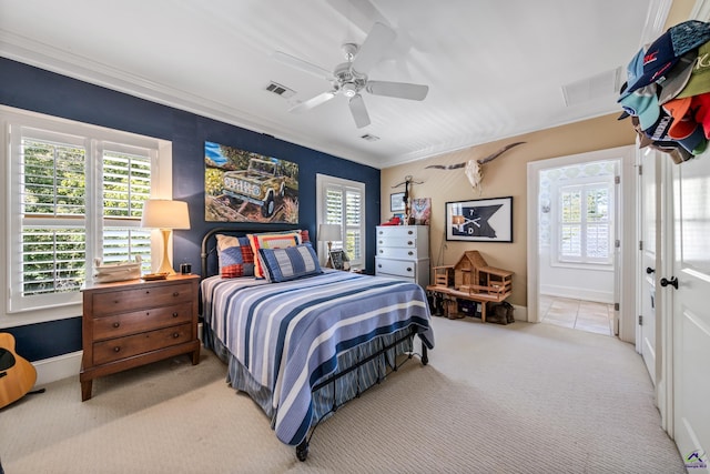 bedroom with baseboards, visible vents, ceiling fan, ornamental molding, and carpet floors