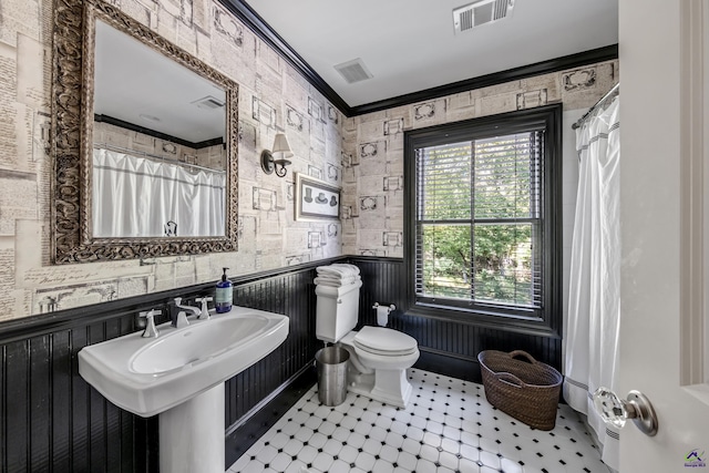 full bathroom with a wainscoted wall, ornamental molding, visible vents, and toilet