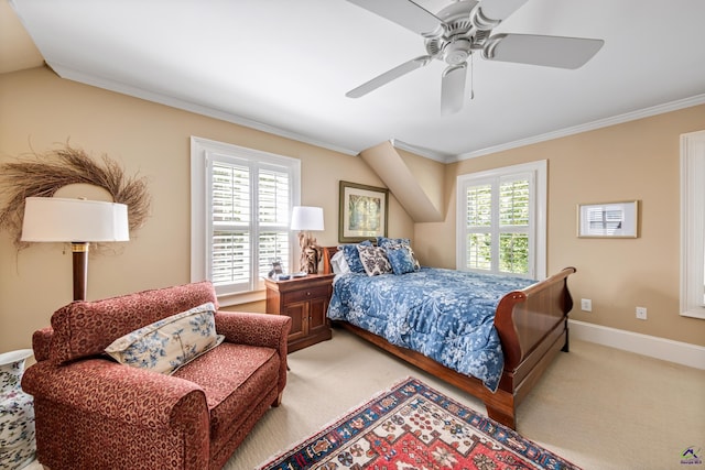 carpeted bedroom with lofted ceiling, baseboards, ornamental molding, and ceiling fan