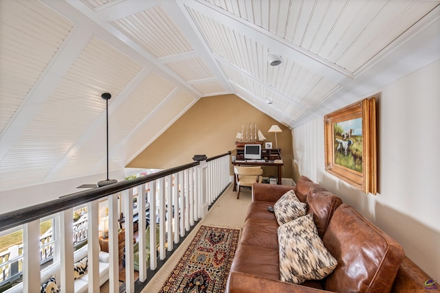 sitting room featuring carpet floors and vaulted ceiling