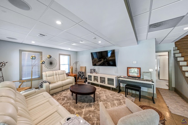 living room featuring a drop ceiling, recessed lighting, visible vents, baseboards, and stairway