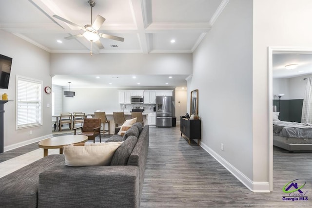 living room with coffered ceiling, baseboards, and dark wood finished floors