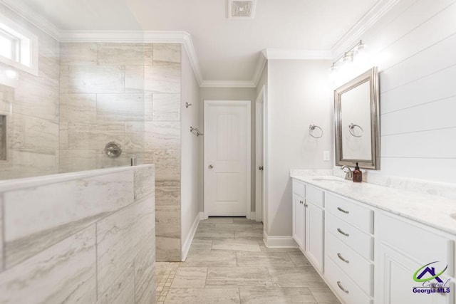 bathroom with baseboards, visible vents, walk in shower, crown molding, and vanity