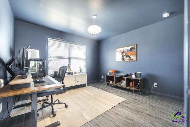 office area featuring baseboards and wood finished floors