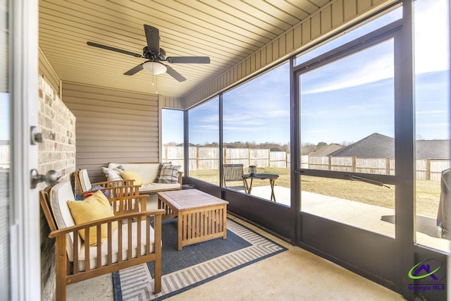 sunroom / solarium featuring ceiling fan