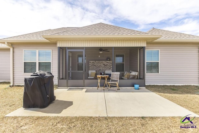 rear view of house with a patio, roof with shingles, a sunroom, and a ceiling fan