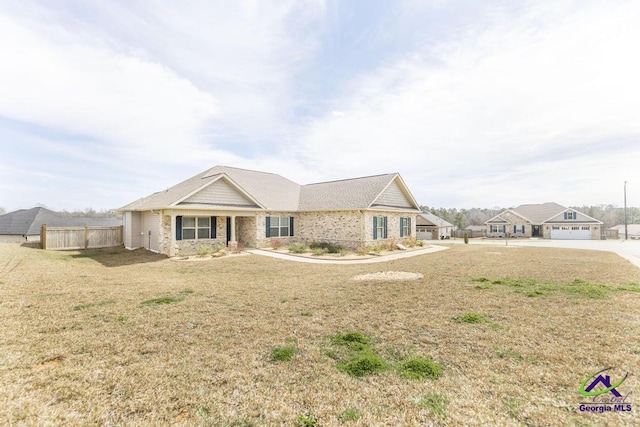 view of front of property with fence and a front lawn