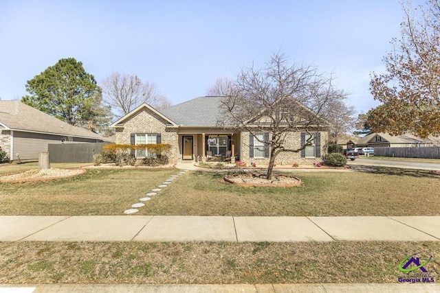 ranch-style home with fence, a front lawn, and brick siding