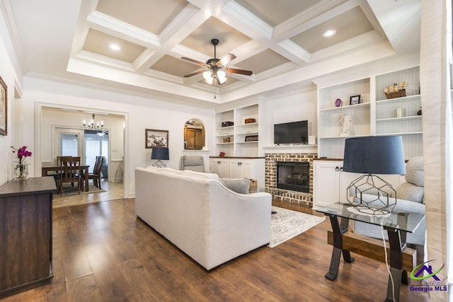 living room featuring dark wood-style floors, ceiling fan, coffered ceiling, and crown molding