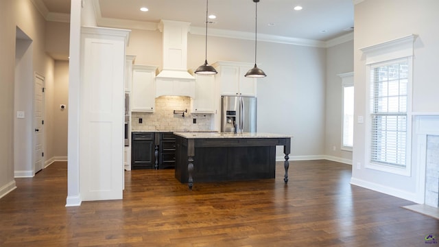 kitchen with dark wood-style floors, ornamental molding, backsplash, and stainless steel fridge with ice dispenser