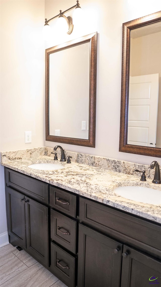 full bathroom featuring double vanity, a sink, and wood finished floors