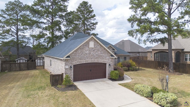 view of front of house featuring driveway, a front lawn, fence, and brick siding