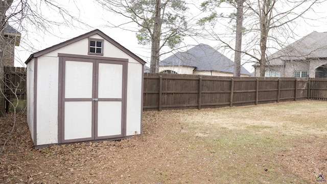 exterior space featuring a shed, an outdoor structure, and a fenced backyard