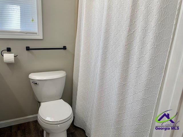 bathroom featuring baseboards, toilet, and wood finished floors