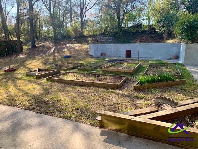 view of yard with a vegetable garden and fence