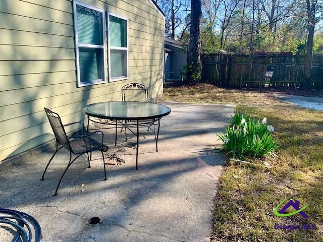 view of patio featuring fence