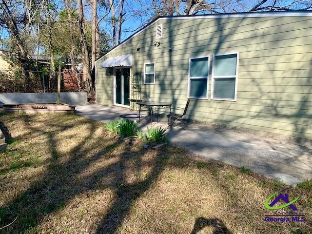 exterior space featuring a patio, a lawn, and fence