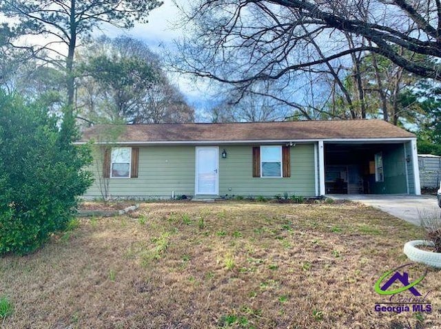 single story home with an attached carport, concrete driveway, and a front yard