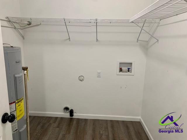 washroom featuring laundry area, dark wood-type flooring, hookup for a washing machine, and electric water heater