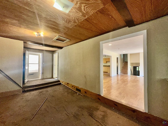 spare room with attic access and wood ceiling