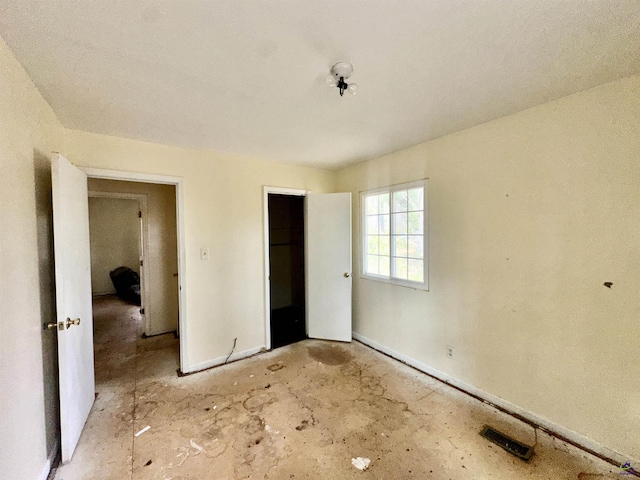 unfurnished bedroom featuring visible vents and a closet