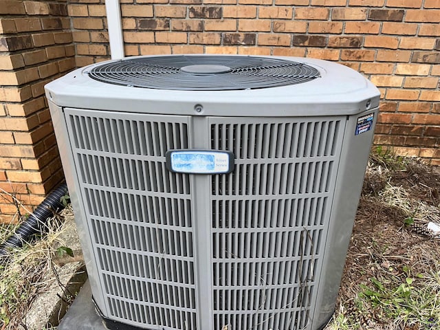 exterior details with central AC and brick siding