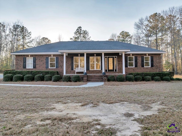 ranch-style house featuring a porch and brick siding