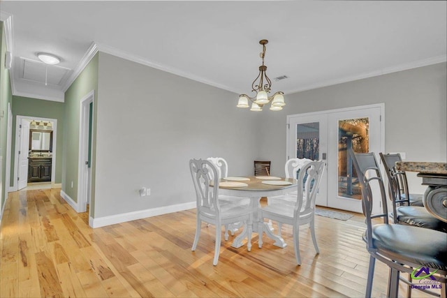 dining area with light wood-style flooring, baseboards, ornamental molding, french doors, and attic access