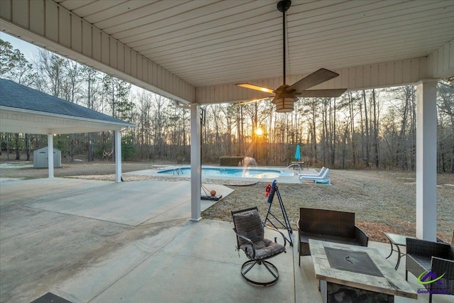 view of patio with a storage unit, a fenced in pool, and an outdoor structure