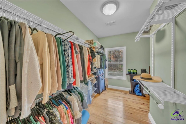 walk in closet featuring visible vents and hardwood / wood-style floors